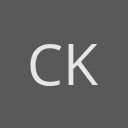 Charles Komanoff avatar consisting of their initials in a circle with a dark grey background and light grey text.