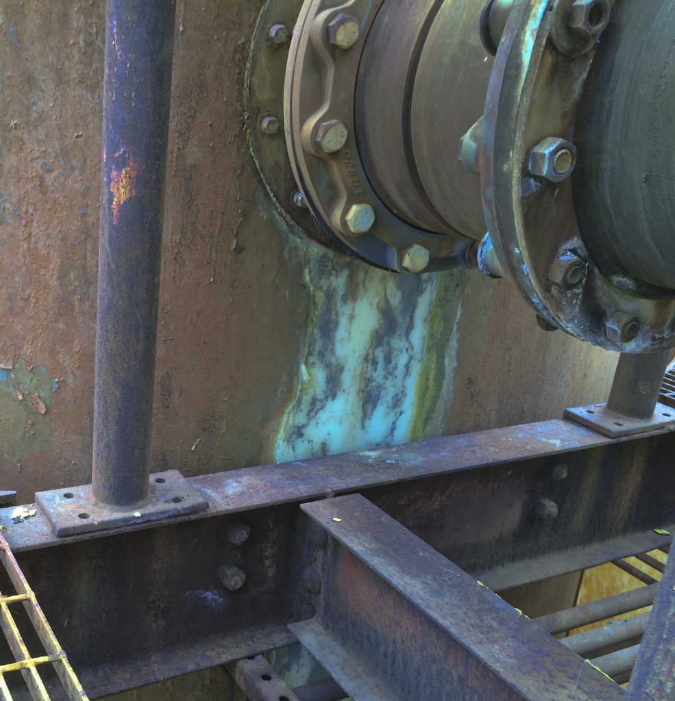 April 18, 2014 -- Leaking gasket at reaction tank - acidic waste has removed the protective coating. (Source: DTSC)