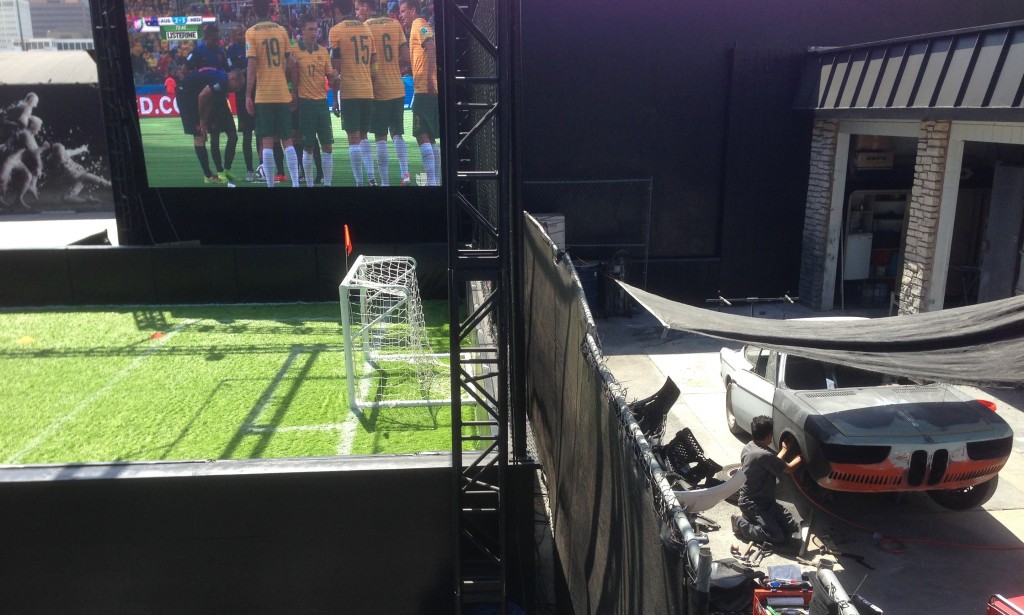 At Niky's Sports, big screen to the left, working auto to the right, behind a fence. Photo: Joe Linton/Streetsblog L.A. 