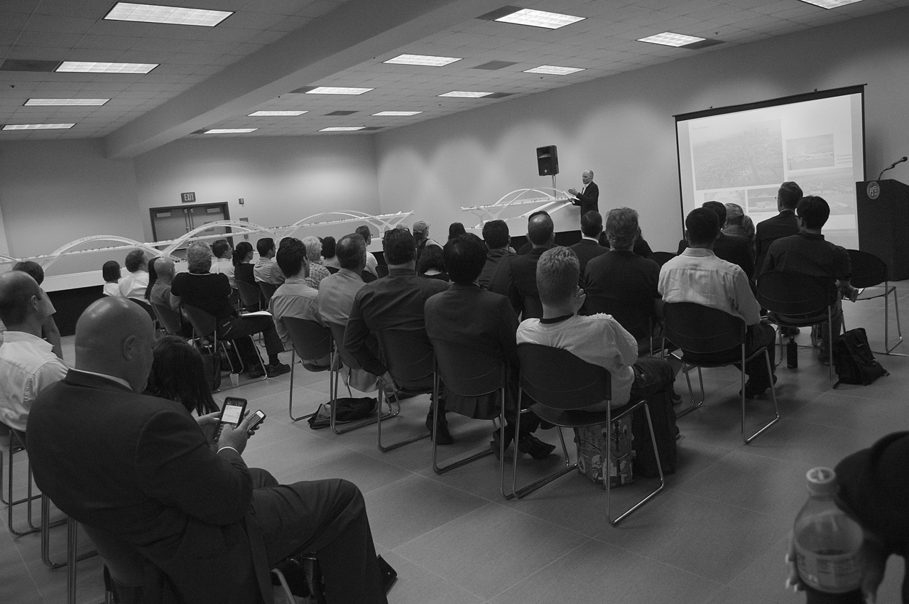 Architect Michael Maltzan describes the 47-foot model of the bridge at a packed public briefing at the Puente Learning Center. Sahra Sulaiman/Streetsblog LA
