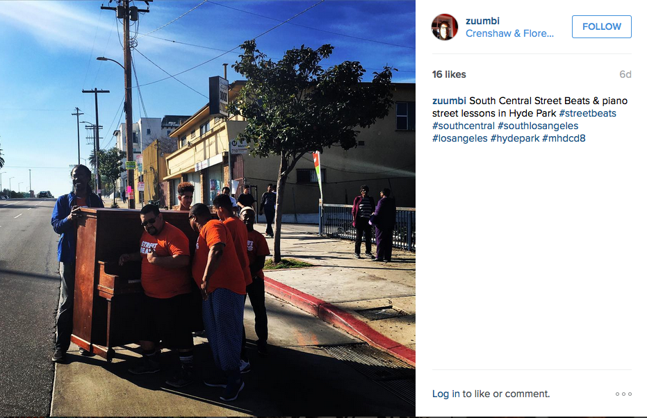 TRUST's Malcolm Harris captured the Street Beats team and neighborhood volunteers moving the piano to the southwest corner.