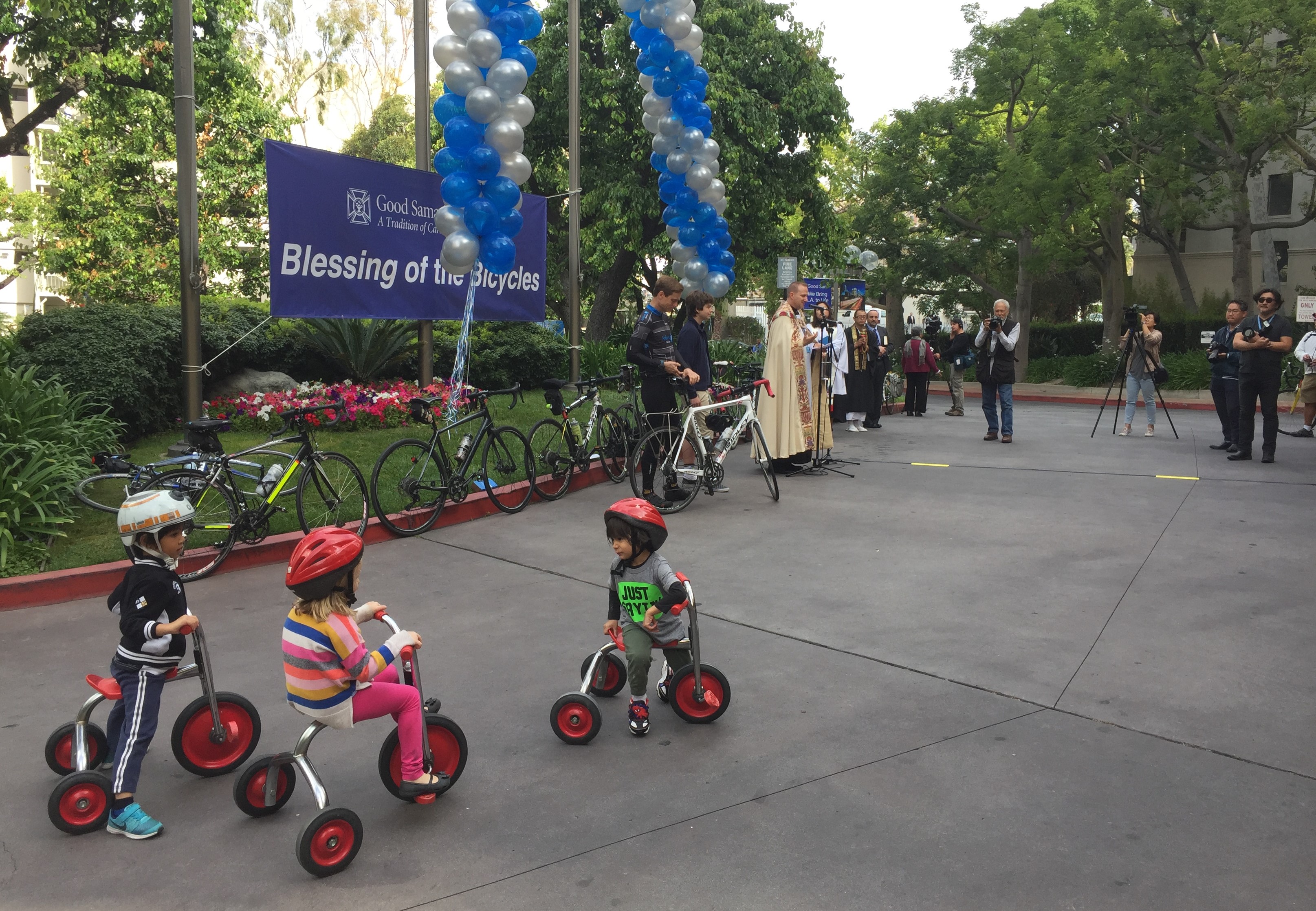 Young tricyclists ready to blessed