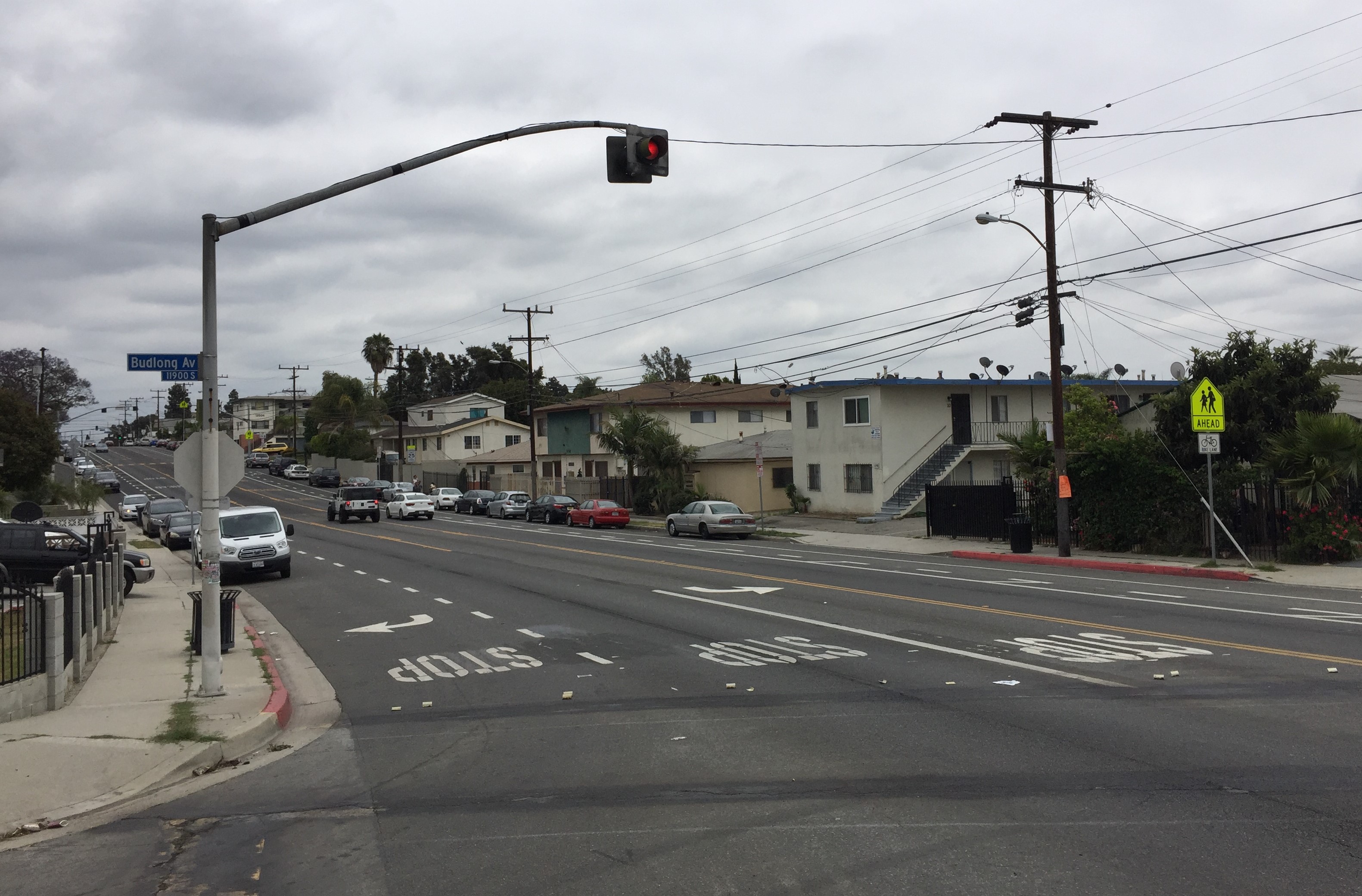 Construction underway at Budlong and 120th Street. The crosswalks have been scraped. There's a new flashing red light signal above.