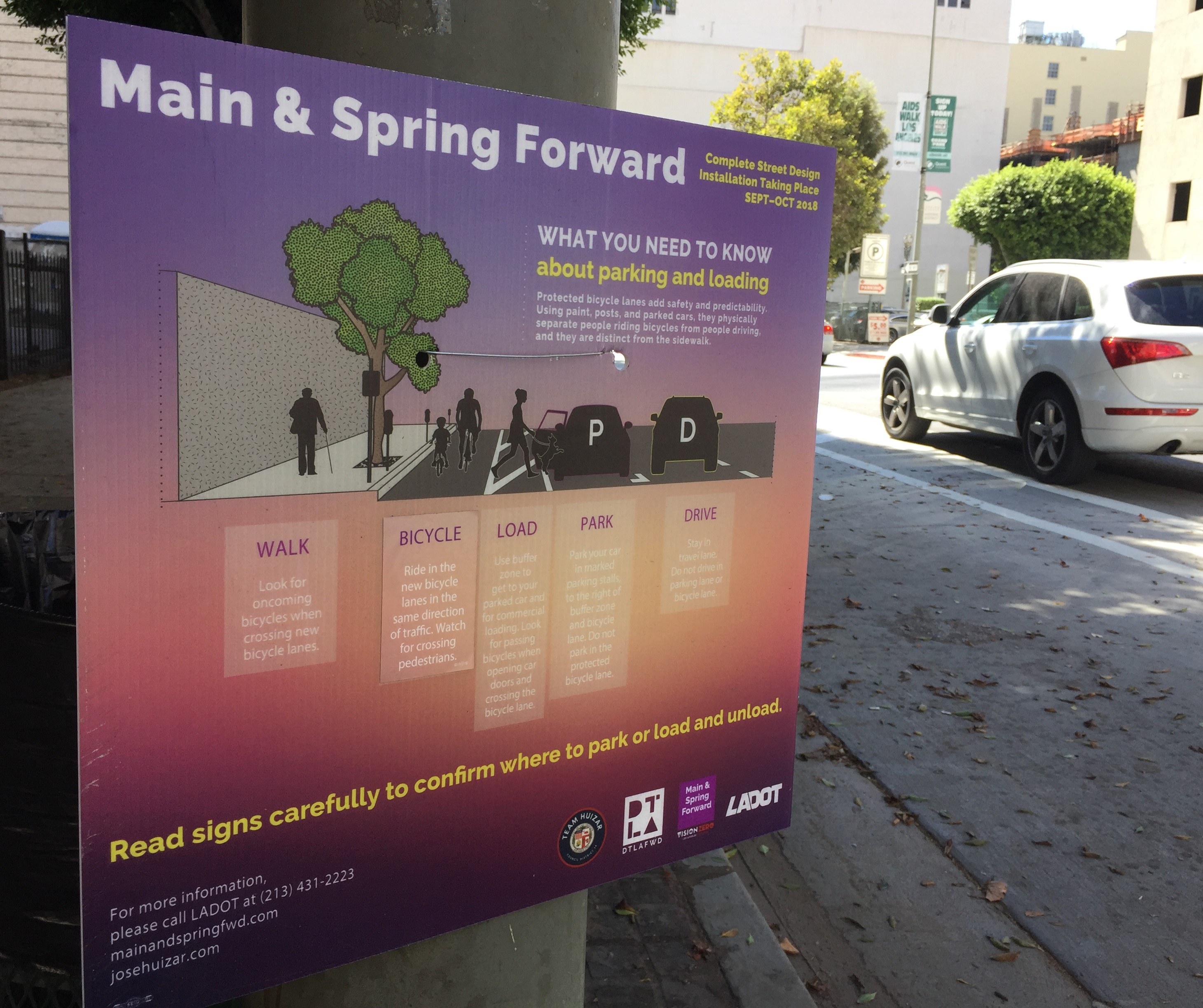 Temporary signage (in English and Spanish) alterts people how to use the use the new lanes