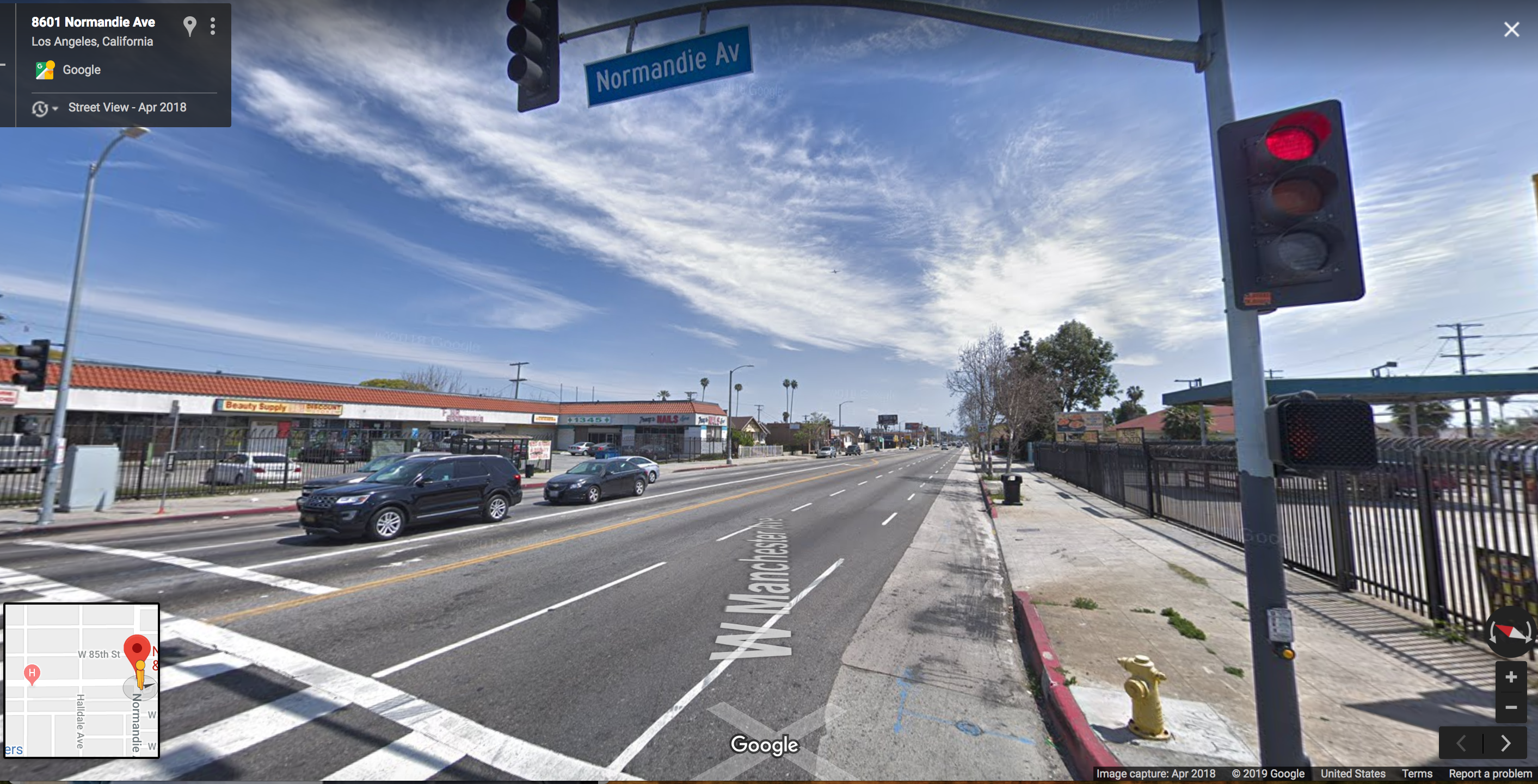 The gutter lane on Manchester and Normandie. On the day he was hit, Woon would have seen parked cars just up ahead near the trees. The narrow strip of asphalt between the lane markers and the cement is often the only safe space open to cyclists between fast-moving traffic and parked cars. Source: Google maps