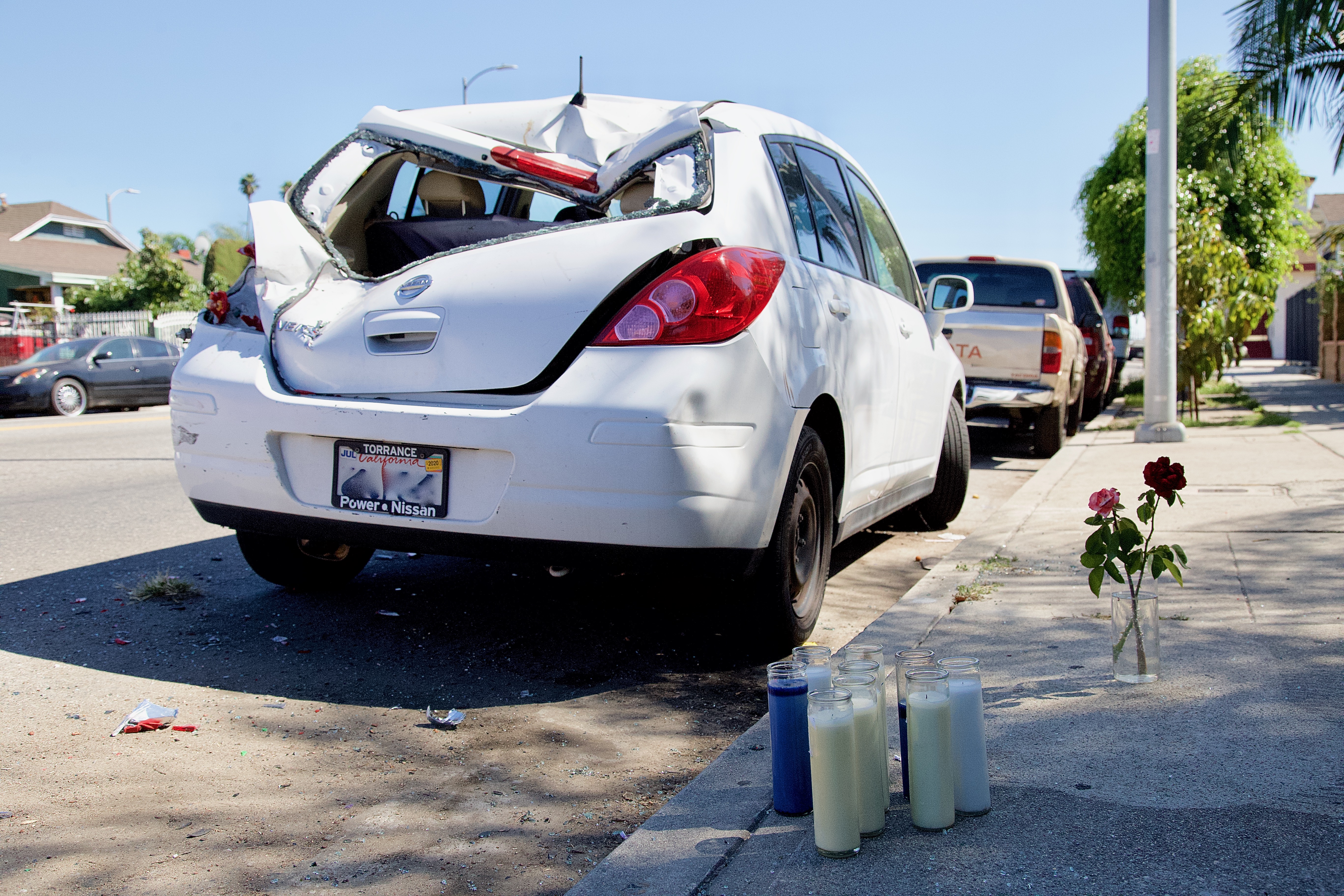 At 51st and Normandie, a parked car's back end is a reminder of just how much damage a fast-moving multi-ton vehicle can do when it connects with a human body. The pedestrian struck by a hit-and-run driver flew several feet before landing on the vehicle, smashing the back window out and crushing the vehicle's shell. Sahra Sulaiman/Streetsblog L.A.