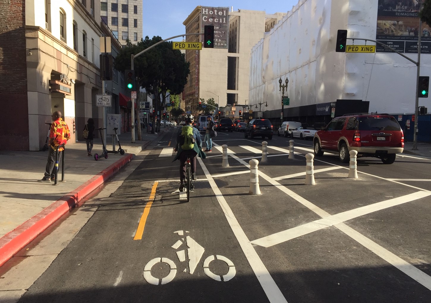 The new protected bikeway is on the left side of Main Street - in order to prevent conflict between cyclists and transit
