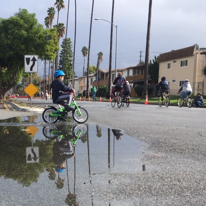 Young cyclists know the appeal of puddles