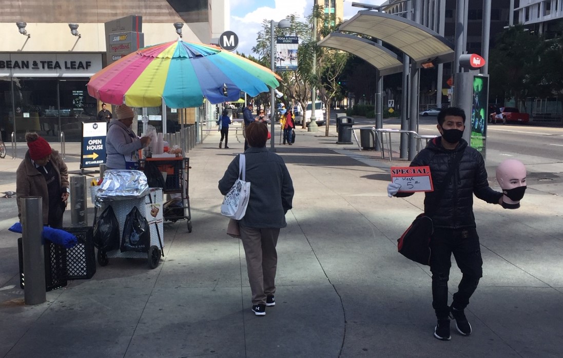 Street vendor selling masks at Wilshire/Vermont. Photo by Joe Linton/Streetsblog L.A.