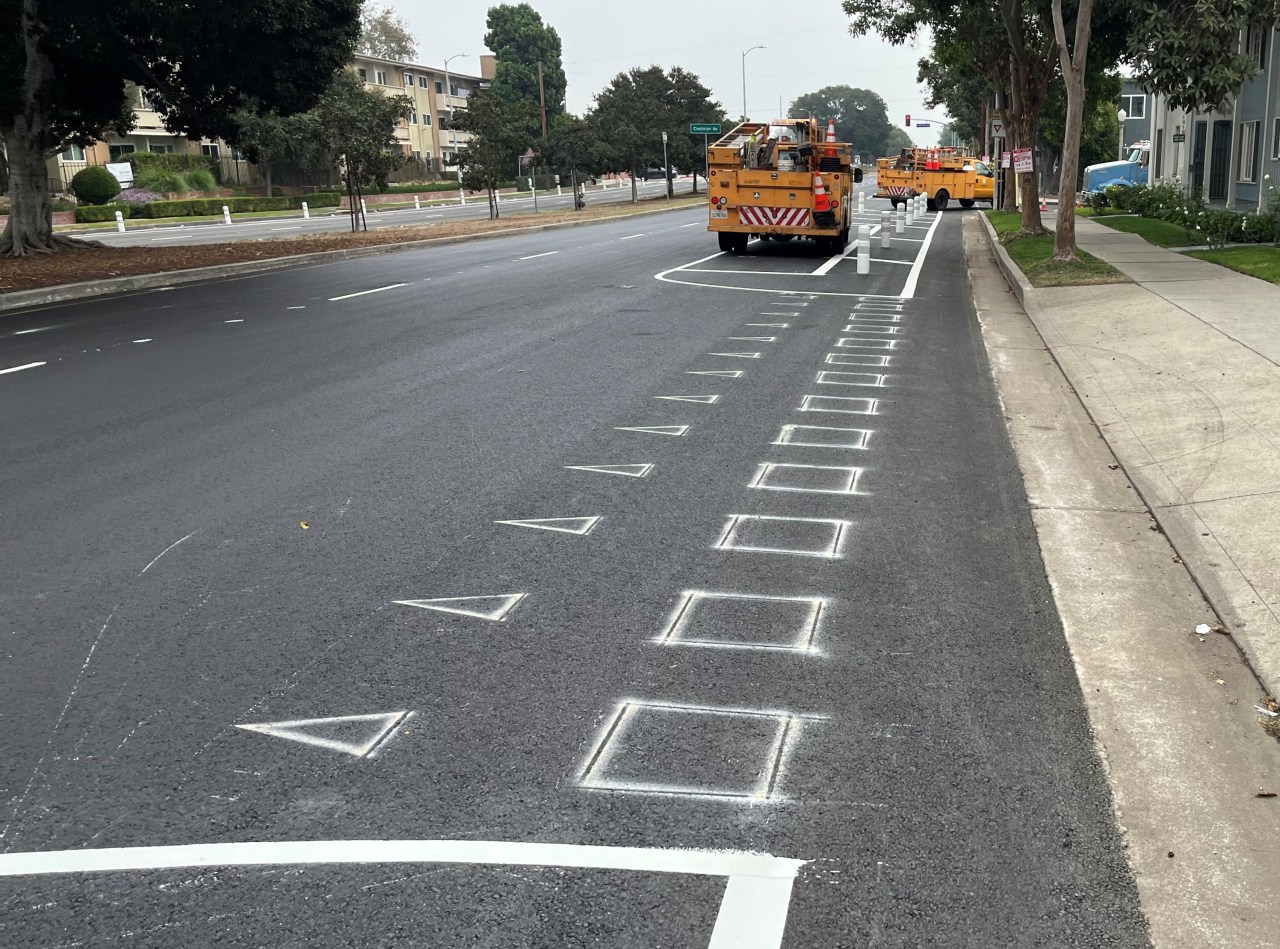 Much of the thermoplastic striping is done, but a few preliminary markings are still visible
