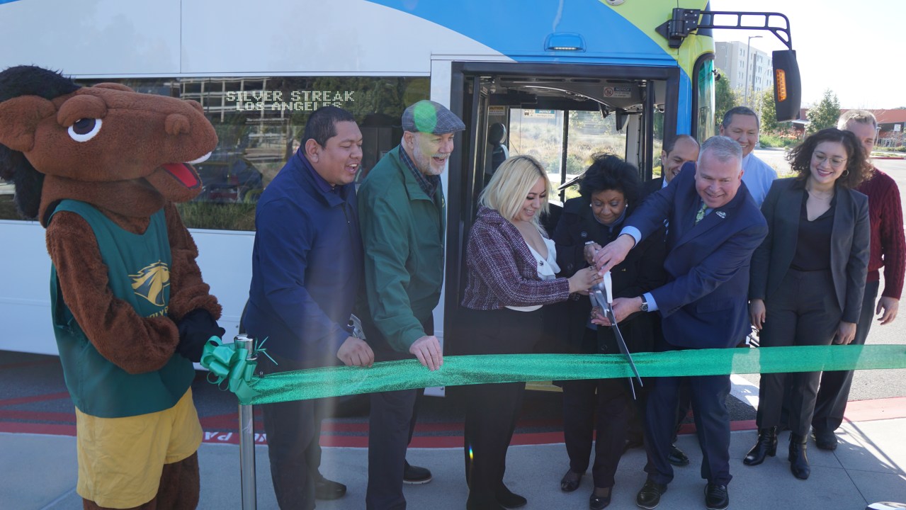 The ribbon cutting for the grand opening of Foothill Transit's Silver Streak stop at Cal Poly Pomona. L-R: Billy Bronco, Victor Preciado, John Lloyd, Aliza Ortega, Soraya Coley, Corey Calaycay, Doran Barnes, Tim Sandoval, and others. Credit: Chris Greenspon/SBLA